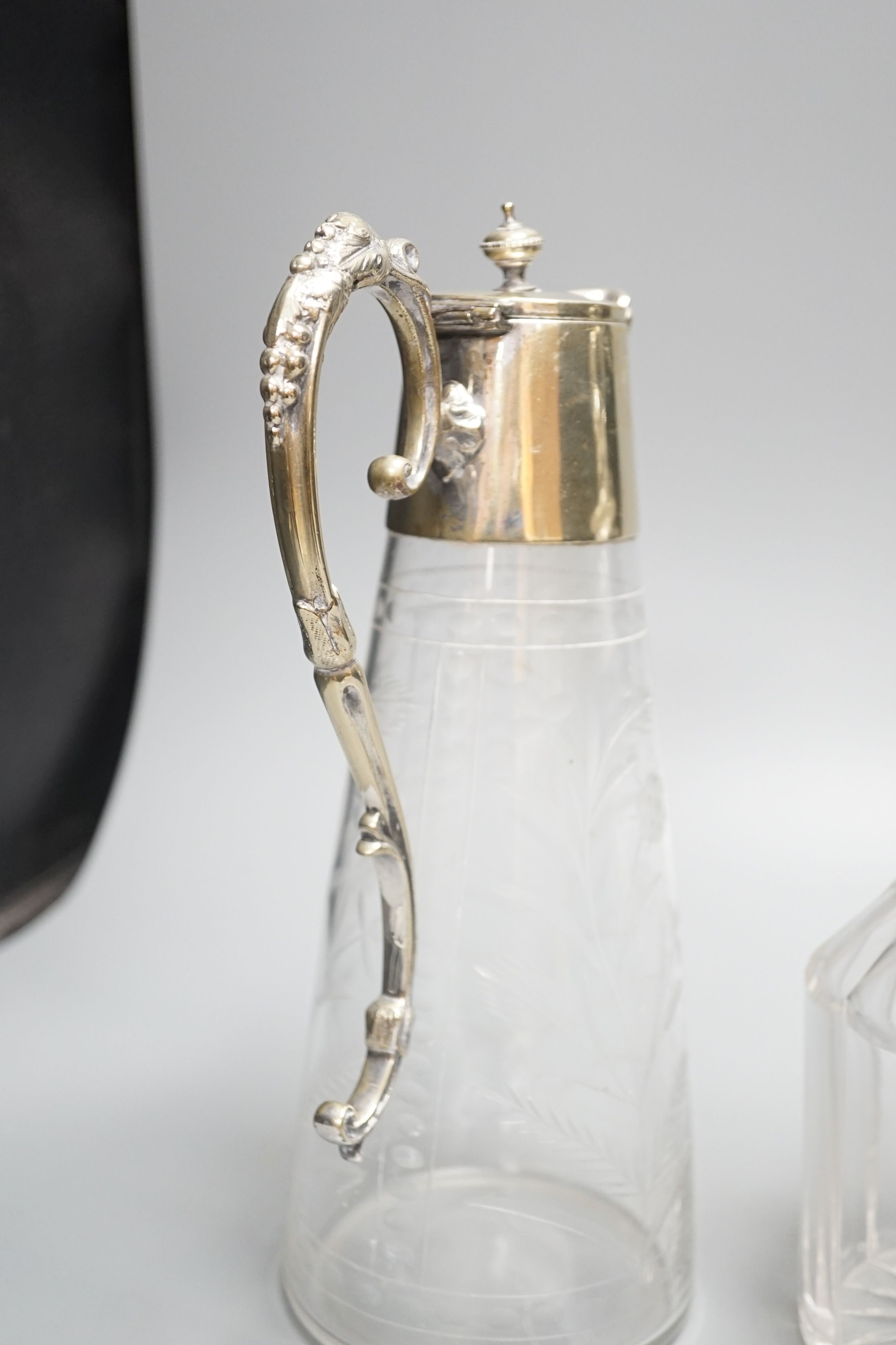 Two cut glass decanters and a claret jug 30cm